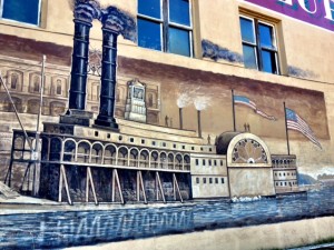 black smoke stacks on boat on mural