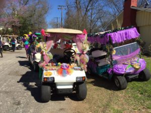 golf carts decorated in pink, green and brown ribbons