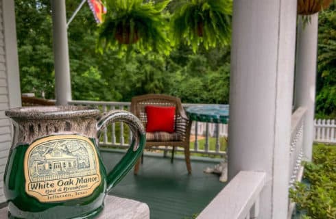 green mug sitting on a white railing