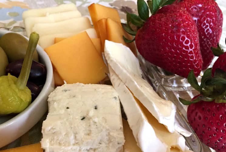 white and orange cheese slices, a bowl of green peppers and strawberries