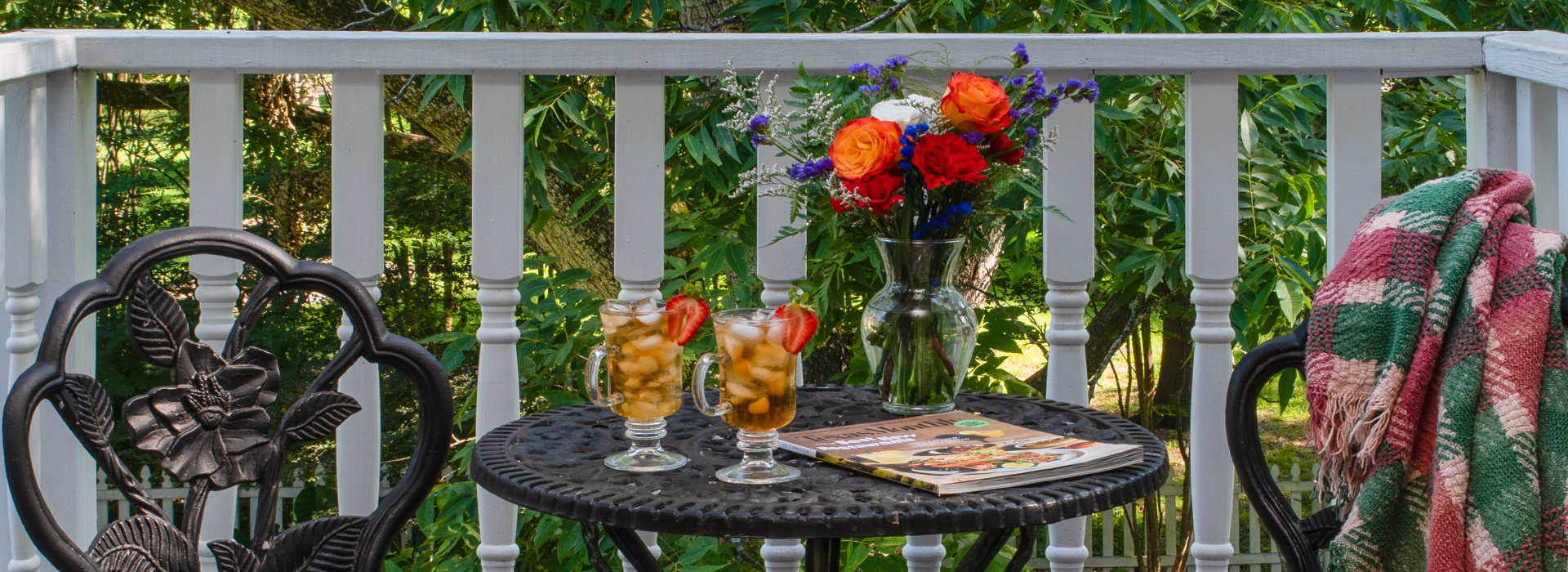 bouquet of flowers with tea glasses on a metal scroll table