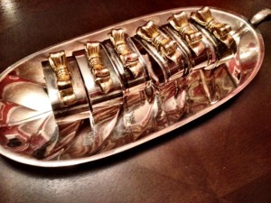gold and silver napkin rings on a silver tray