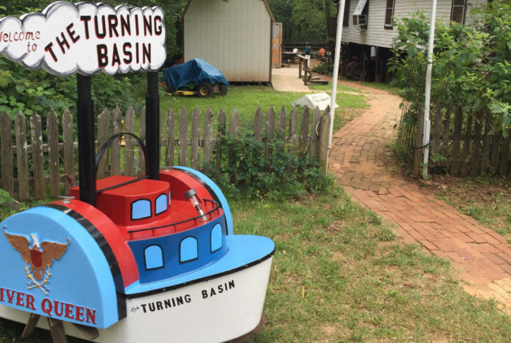 a red, white and blue boat shaped sign
